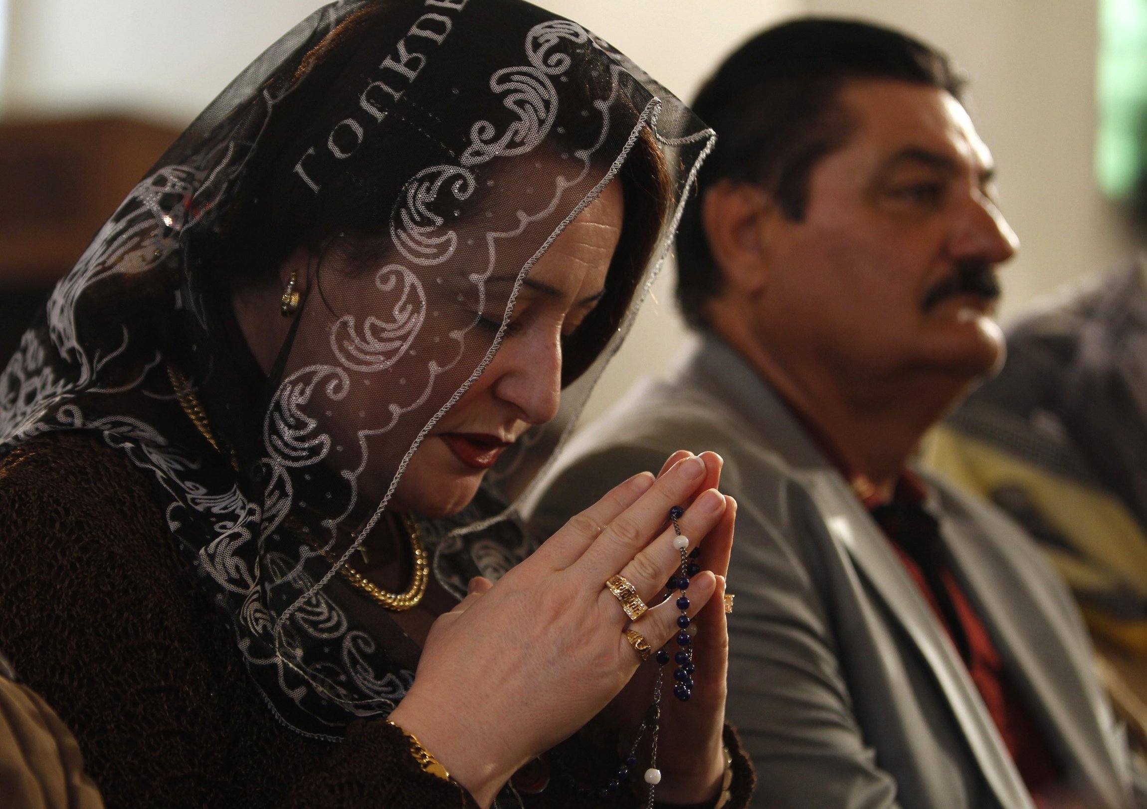 An Iraqi woman prays during a 2011 Christmas Mass at St. Joseph Chaldean Catholic Church in Baghdad. During a Sept. 24 event in Rome, Iraq's ambassador to the Vatican, Habbeb Mohammed Hadi Ali Sadr, urged Arab nations to support the presence of Christians within their own borders and abroad. (CNS photo/Saad Shalash, Reuters) (Sept. 25, 2012) See IRAQ-CHRISTIANS Sept. 25, 2012.